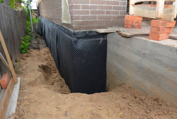 SJ Waterproofing Pros technician performing targeted Sump Pump Installation assessment in Decatur, AL